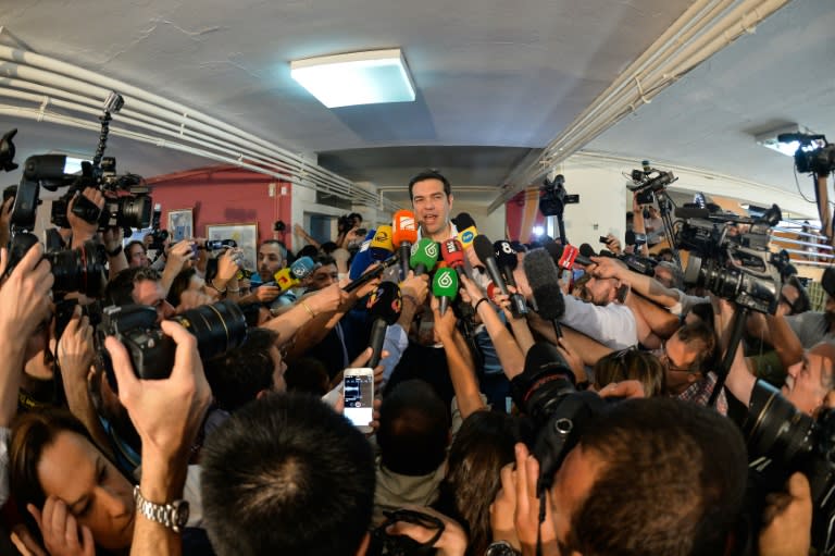 Greek Prime Minister Alexis Tsipras speaks to journalists after voting at a polling station in Athens during the Greek referendum on July 5, 2015