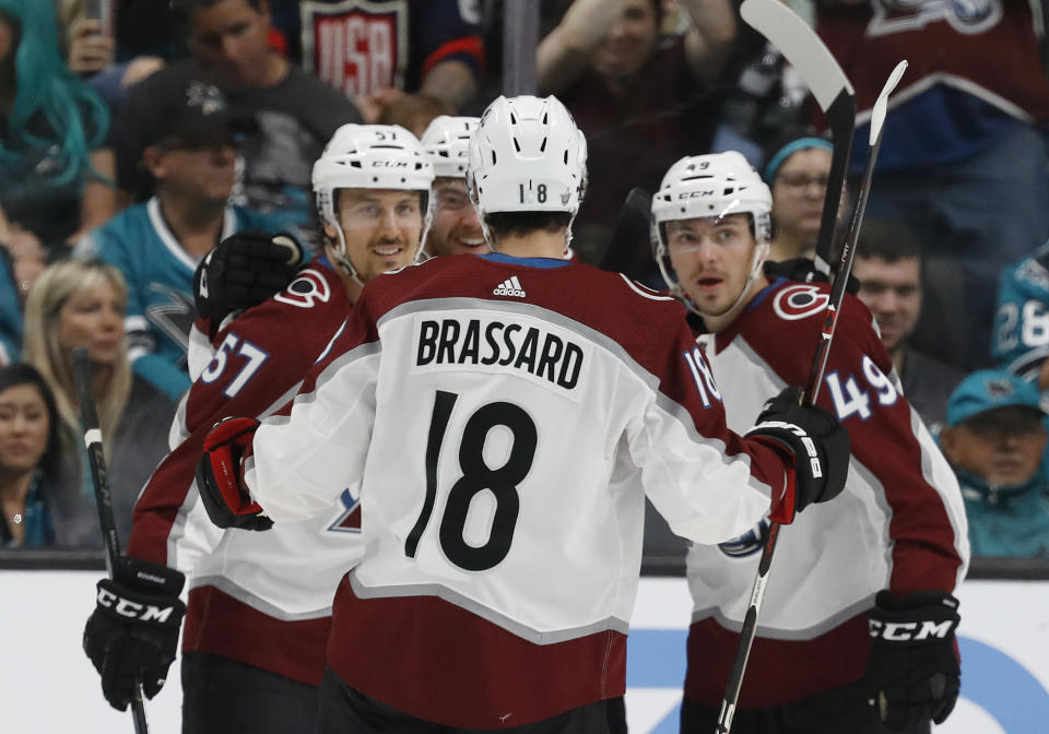 Colorado Avalanche's Gabriel Bourque (57) celebrates his goal against the San Jose Sharks with Derick Brassard (18) and Samuel Girard (49) in the first period of Game 1 of an NHL hockey second-round playoff series at the SAP Center in San Jose, Calif., on Friday, April 26, 2019. (AP Photo/Josie Lepe)