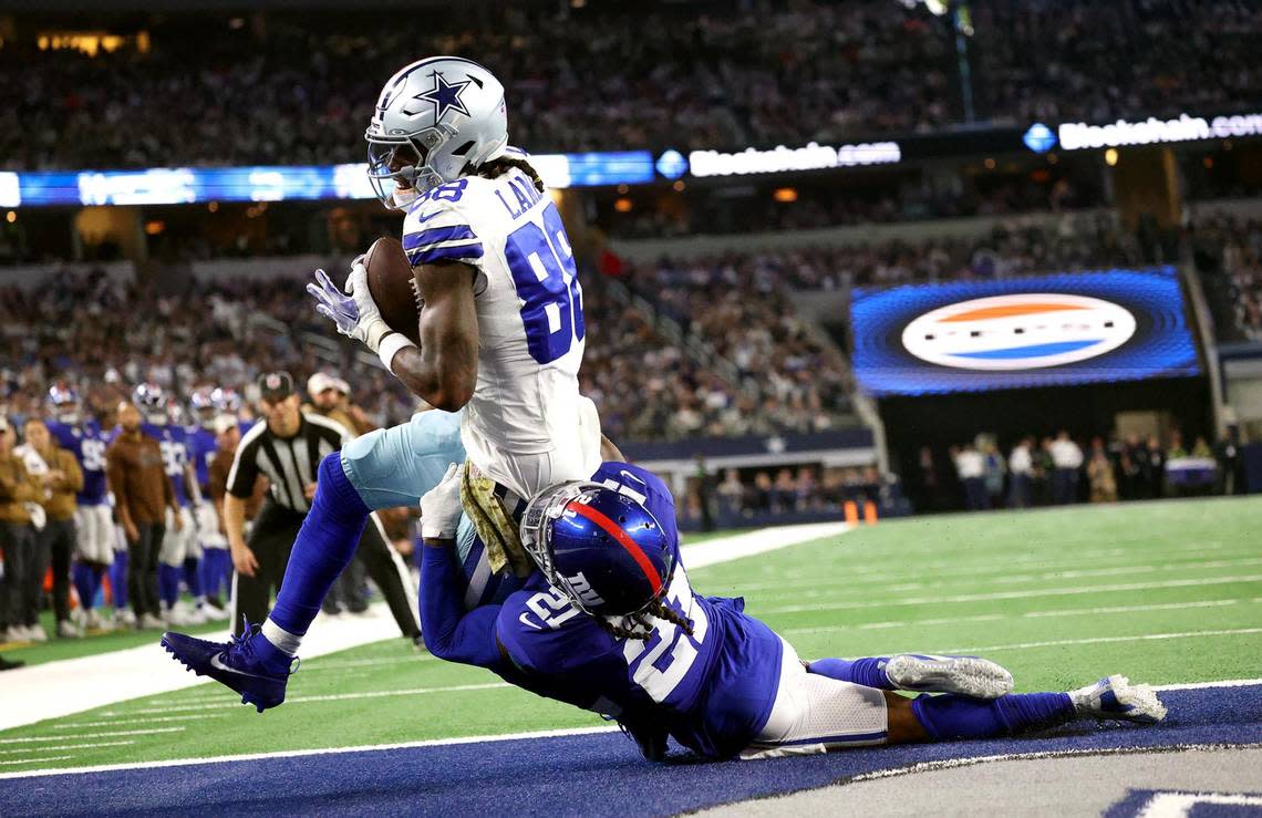 Dallas Cowboys wide receiver CeeDee Lamb pushes past New York Giants safety Bobby McCain to score a touchdown on Sunday, November 12, 2023, at AT&T Stadium in Arlington. Amanda McCoy/amccoy@star-telegram.com