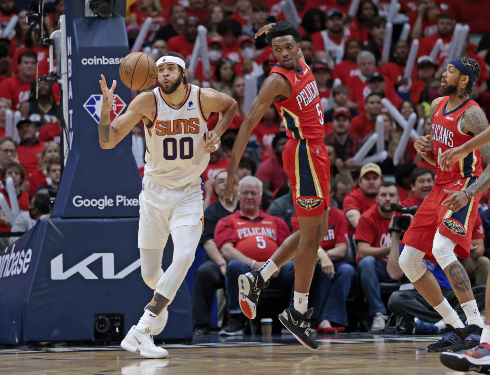 Phoenix Suns center JaVale McGee (00) reaches for a rebound during the first half of Game 3 of an NBA basketball first-round playoff series against the New Orleans Pelicans in New Orleans, Friday, April 22, 2022. (AP Photo/Michael DeMocker)