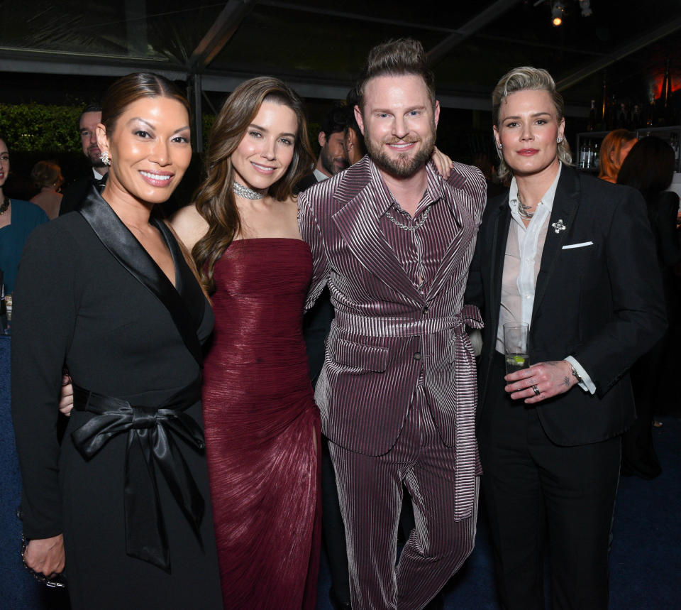 Sophia Bush, Ashlyn Harris, and Bobby Berk posing at an event