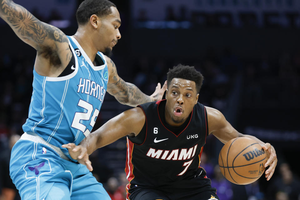 Miami Heat guard Kyle Lowry (7) drives into Charlotte Hornets forward P.J. Washington (25)during the second half of an NBA basketball game in Charlotte, N.C., Sunday, Jan. 29, 2023. Charlotte won 122-117. (AP Photo/Nell Redmond)