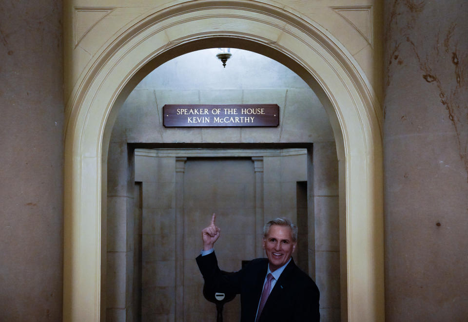 Washington , D.C.  - January 6:   Newly-elected Speaker of the House Kevin McCarthy (R-Calif.) points to a newly installed sign above his office after he was elected in 15 rounds of votes in a meeting of the 118th Congress, Friday, January 6, 2023, at the U.S. Capitol in Washington DC.  The House reconvened Friday night after adjourning earlier for a fourth day of voting after Rep.-elect Kevin McCarthy failed to earn more than 218 votes on 11 ballots over three days.   (Photo by Elizabeth Frantz/For The Washington Post via Getty Images)