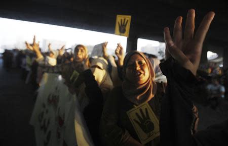 Members of the Muslim Brotherhood and supporters of ousted Egyptian President Mohamed Mursi shout slogans against the military and interior ministry, as they show the "Rabaa" or "four" gesture, in reference to the police clearing of Rabaa al-Adawiya protest camp on August 14, during a rally in the southern suburb of Maadi September 3, 2013. REUTERS/Amr Abdallah Dalsh