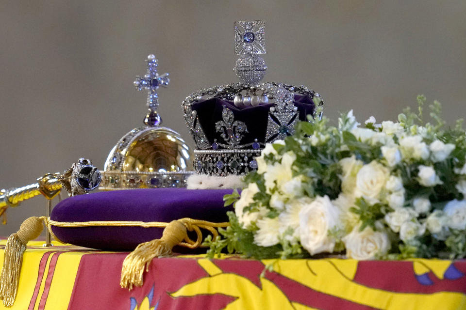 The coffin of Queen Elizabeth II, draped in the Royal Standard with the Imperial State Crown and the Sovereign's orb and sceptre, lying in state on the catafalque as members of the public file past in Westminster Hall, at the Palace of Westminster, London, ahead of her funeral on Monday. Picture date: Friday September 16, 2022.