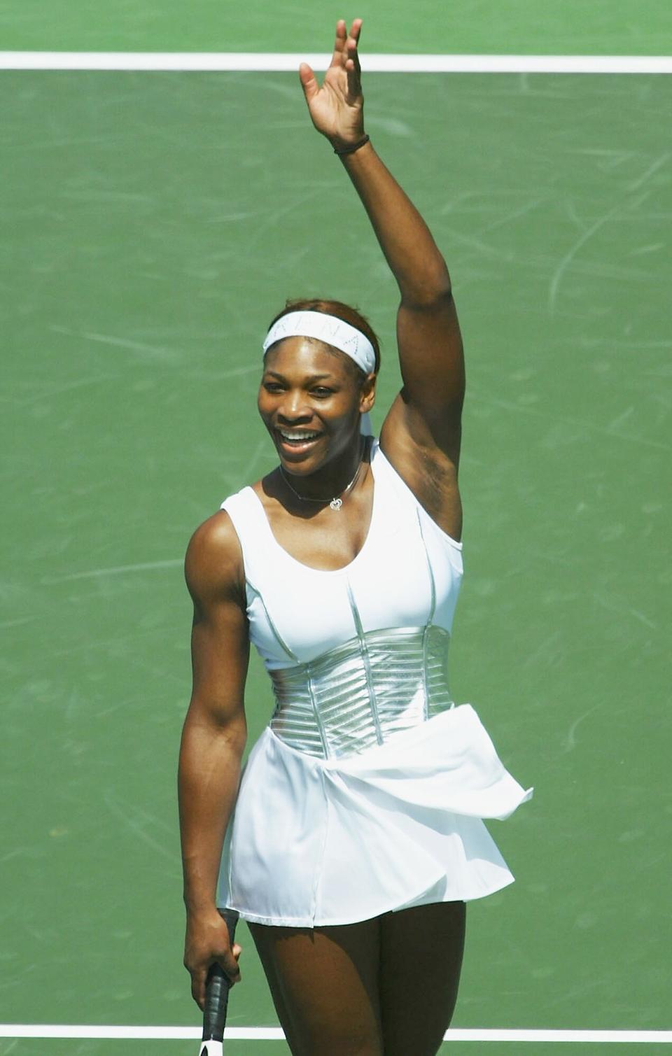 Serena Williams of the USA waves to the crowd after defeating Marta Marrero of Spain during The Nasdaq 100 on March 26, 2004 in Miami, Florida