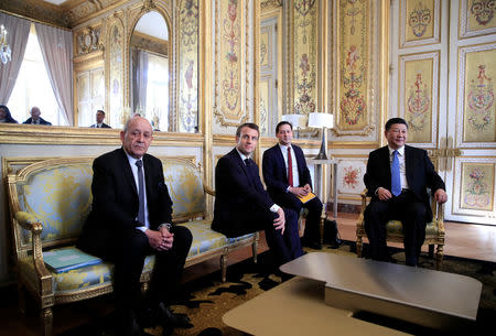 French President Emmanuel Macron and French Foreign Minister Jean-Yves Le Drian attend a meeting with Chinese President Xi Jinping at the Elysee Palace in Paris, France, March 25, 2019. REUTERS/Gonzalo Fuentes/Pool