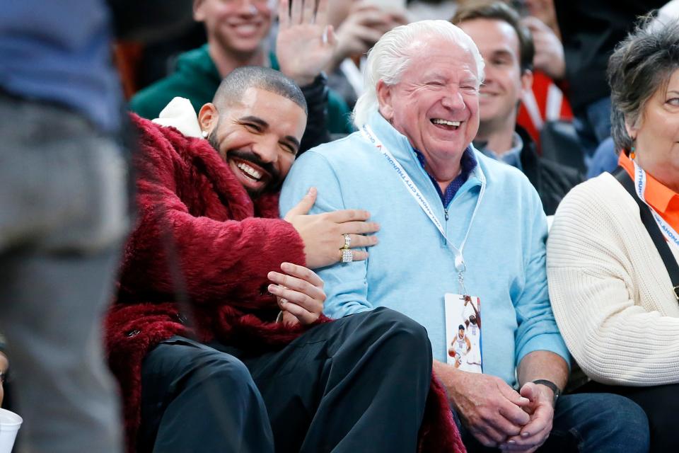 Drake, at left, talks with a Thunder fan Jim Stanley during the Rockets' 114-110 win Wednesday night at Paycom Center.