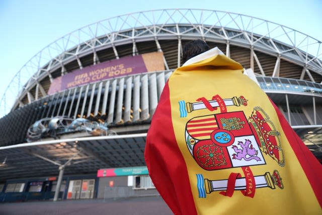 A fan draped in a Spain flag heads towards Stadium Australia for the World Cup final