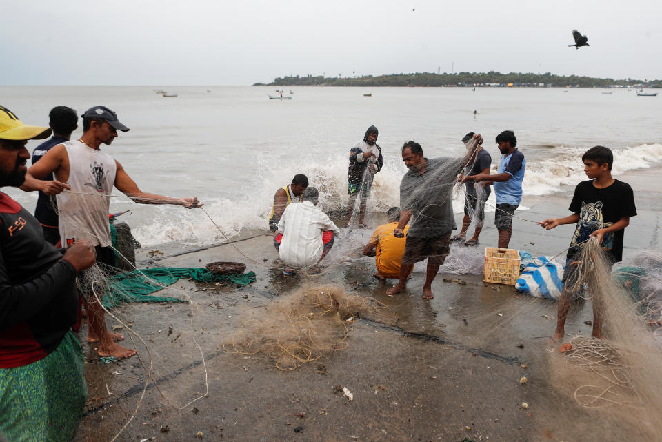 Fishermen gather their nets by the sea shore to store them before cyclone Nisarga makes its landfall, in Mumbai, India June 3, 2020. REUTERS/Francis Mascarenhas