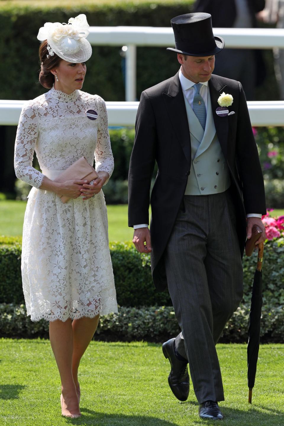 <p>Kate and William arrived at the 2017 race event in a very similar look to last year. The Duchess donned a white lacy dress by Alexander McQueen with a pearl-embroidered hat while William went for a black-and-grey morning suit.<br><i>[Photo: PA]</i> </p>