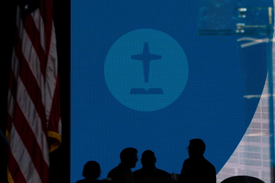 Staff members gather on the stage during the Southern Baptist Convention's annual meeting in Anaheim, Calif., Tuesday, June 14, 2022. (AP Photo/Jae C. Hong)