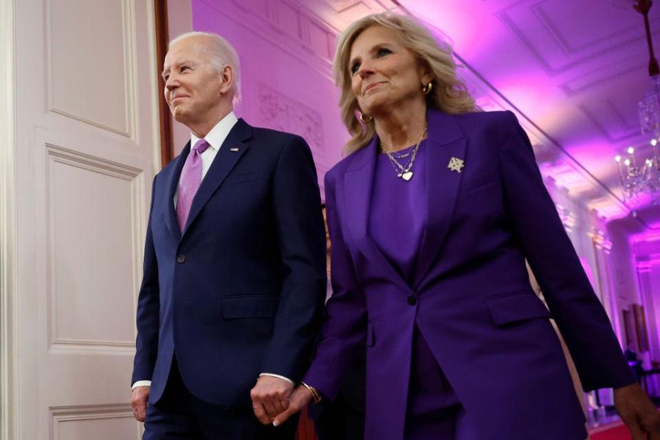 Joe Biden and Jill Biden walk through the White House.