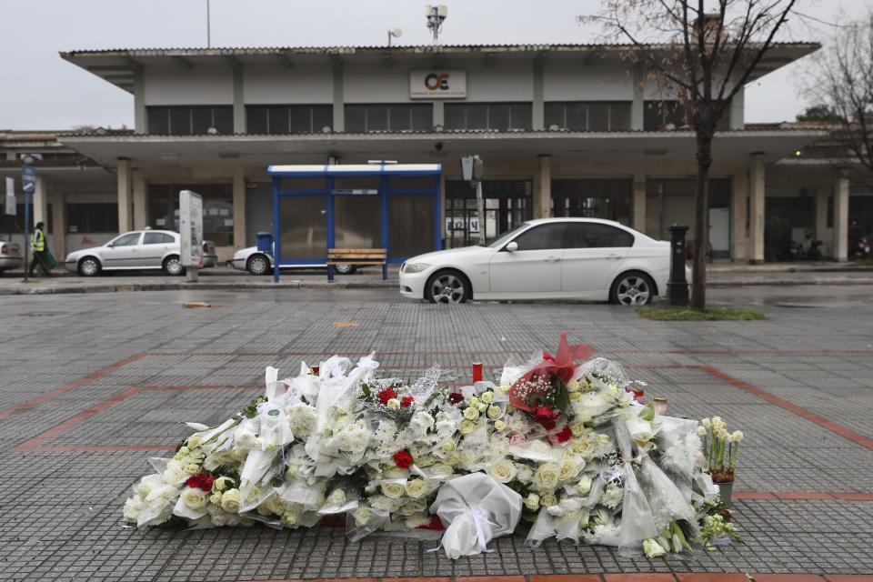 Flowers and candles lie in the memory of the victims of a deadly train crash outside a train station of Larissa city, north of Athens, Greece, Thursday, March 2, 2023. Emergency workers are searching late into the night for survivors and bodies after a passenger train and a freight train crashed head-on in Tempe, central Greece just before midnight Tuesday. It was the country's deadliest rail crash on record. (AP Photo/Vaggelis Kousioras)