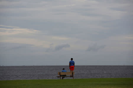 People look at the water as clouds roll in ahead of the arrival of Hurricane Irma in Tampa, Florida, U.S., September 9, 2017. REUTERS/Chris Wattie