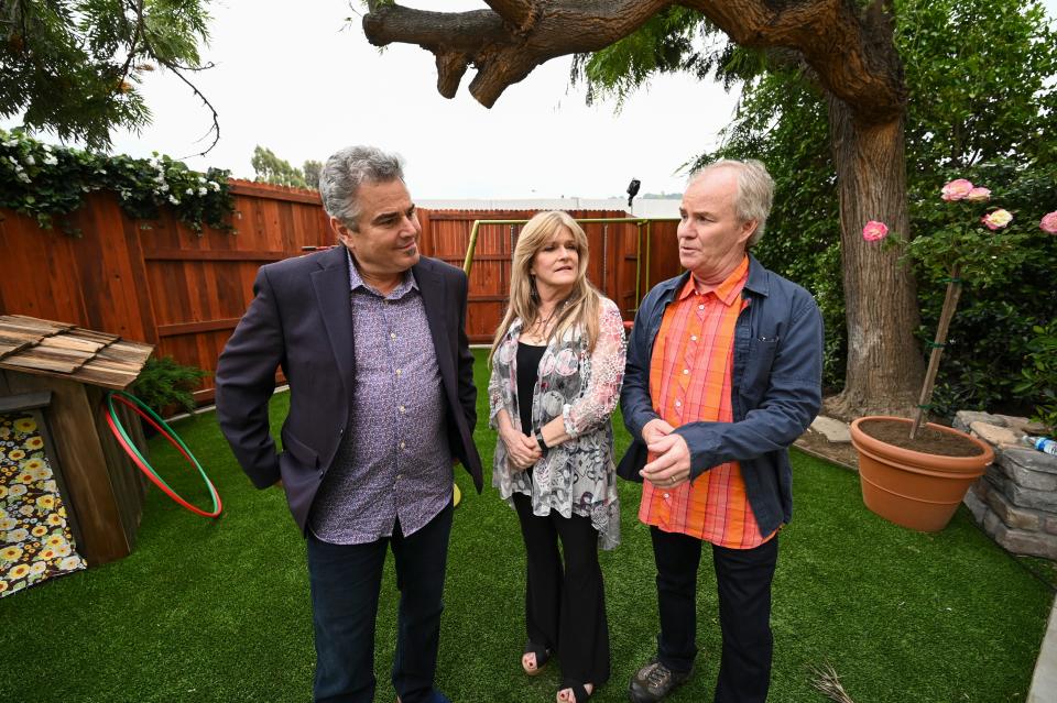 'The Brady Bunch' stars Christopher Knight, left, Susan Olsen and Mike Lookinland stand in the back yard of a Los Angeles home that's been transformed into a duplicate of the sitcom's Paramount Studios set as part of HGTV's 'A Very Brady Renovation.'