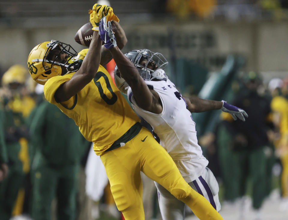 Baylor wide receiver R.J. Sneed, left, pulls in a long pass over Kansas State defensive back Kiondre Thomas, right, in the second half of an NCAA college football game, Saturday, Nov. 28, 2020, in Waco, Texas. (Rod Aydelotte/Waco Tribune-Herald via AP)