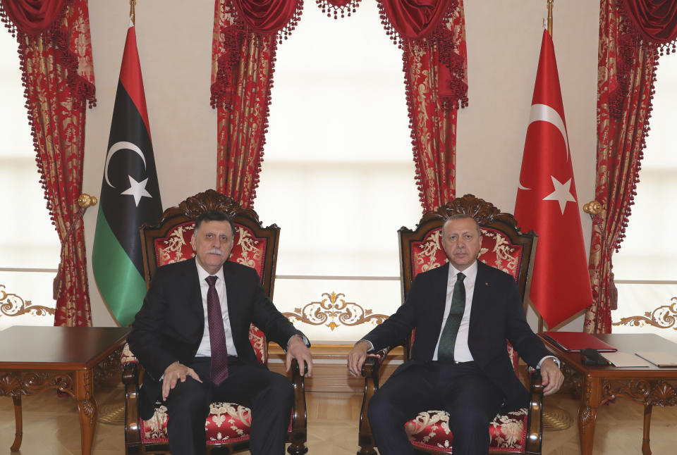 Turkey's President Recep Tayyip Erdogan, right, poses for a photo with Fayez al Sarraj, the head of Libya's internationally-recognized government, in Istanbul, Sunday, Jan. 12, 2020. The meeting at Dolmabahce Palace took place on the first day of a ceasefire in Libya initiated by Turkey and Russia. (Turkish Presidency via AP, Pool)