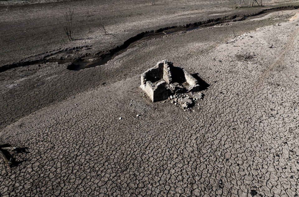 View of Arnius-Boadella reservoir, which is only at 12 percent of its capacity, near Figueras, north of Girona, Spain, Thursday, Jan. 25, 2024. Barcelona and the surrounding area of Spain's northeast Catalonia are preparing to face tighter water restrictions amid a historic drought that has shrunk reservoirs to record lows. Catalonia has recorded below-average rainfall for 40 consecutive months. Experts say that the drought is driven by climate change and that the entire Mediterranean region is forecast to heat up at a faster rate than many other regions in the coming years. (AP Photo/Emilio Morenatti)