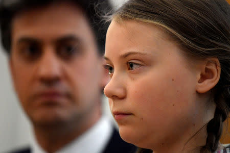 Swedish environmental activist Greta Thunberg looks on next to the former leader of Britain's opposition Labour Party Ed Miliband at the House of Commons as guest of Caroline Lucas, in London, Britain April 23, 2019. REUTERS/Toby Melville