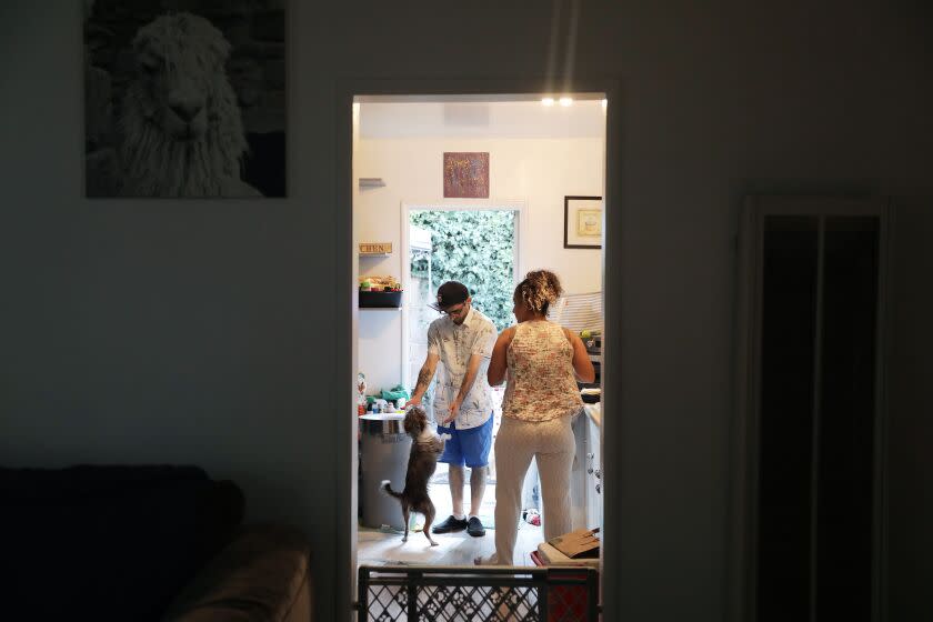 Anthony Mazzucca, center, and his sister Sierra, 33, hang in the kitchen during a family bbq at Sierra's home in Lomita to celebrate Anthony's 31st birthday on Tuesday, April 5, 2022. (Christina House / Los Angeles Times)