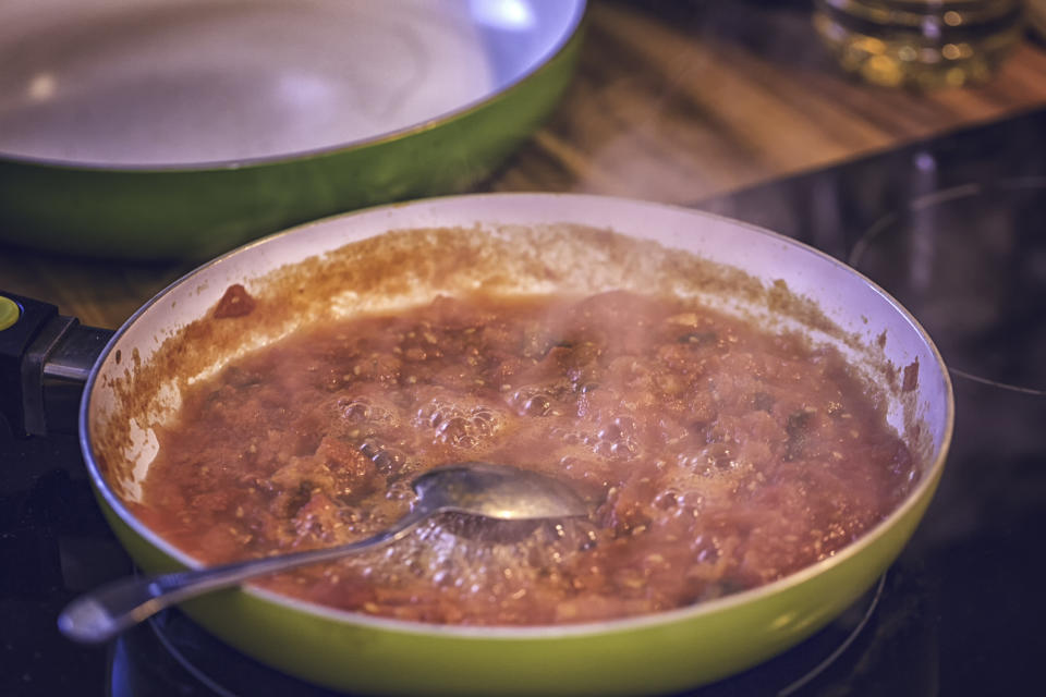 Preparing tomato sauce in a pan