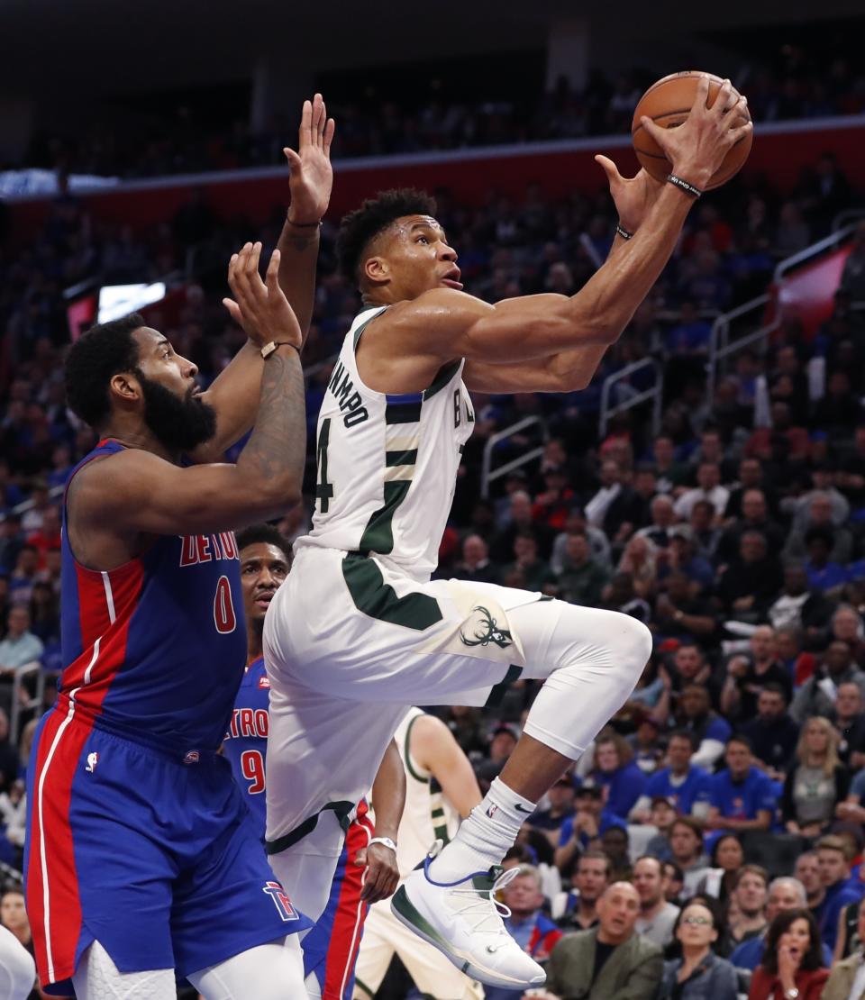 Milwaukee Bucks forward Giannis Antetokounmpo, right, makes a layup as Detroit Pistons center Andre Drummond defends during the first half of Game 3 of a first-round NBA basketball playoff series, Saturday, April 20, 2019, in Detroit. (AP Photo/Carlos Osorio)