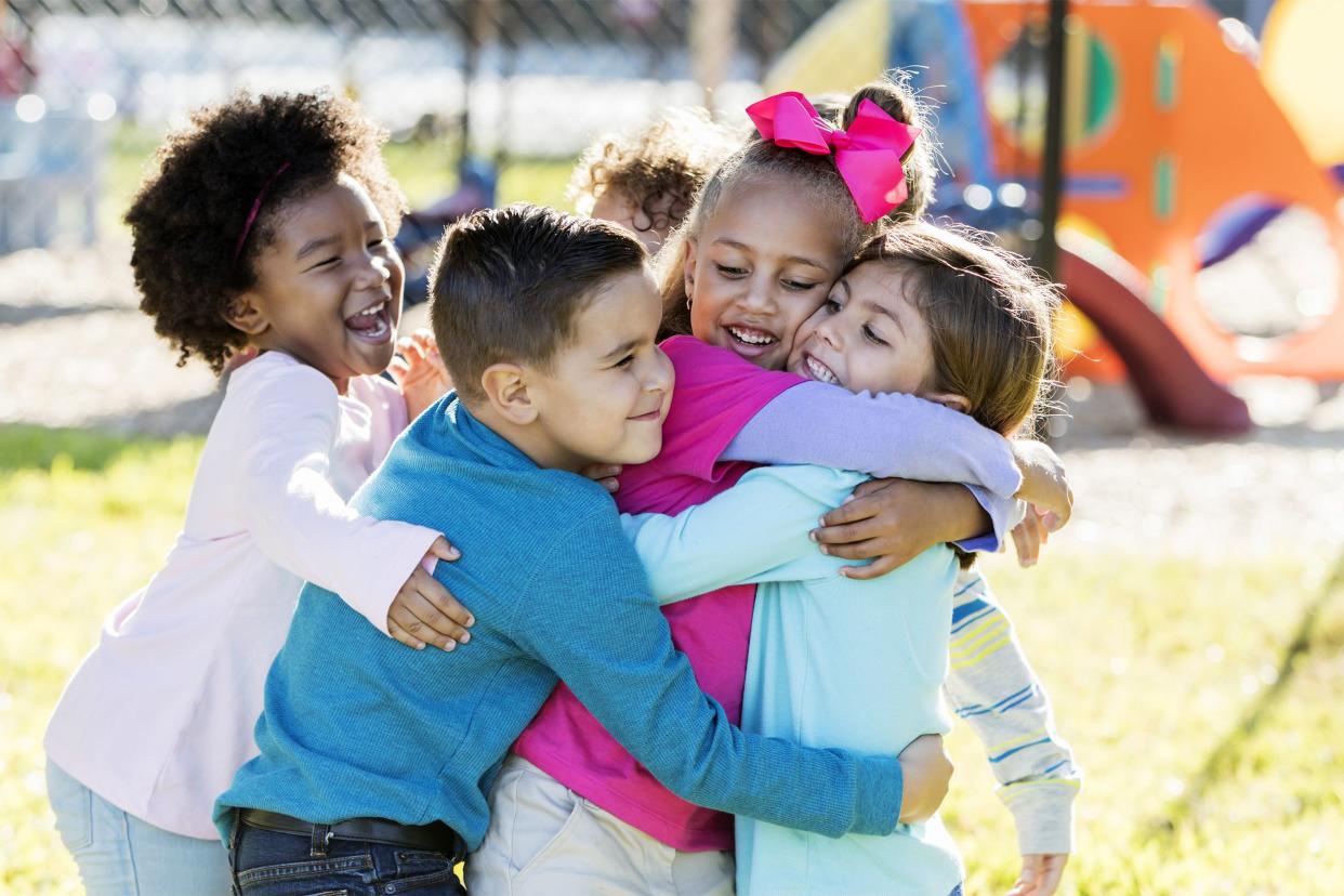 Kids hugging each other on the playground