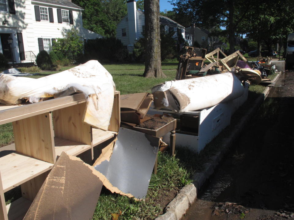 Flood-wrecked household debris sits on a curb in Cranford N.J. on Saturday Sept. 4, 2021, part of a massive cleanup in many areas of New Jersey from damage caused by the remnants of Tropical Storm Ida. (AP Photo/Wayne Parry)