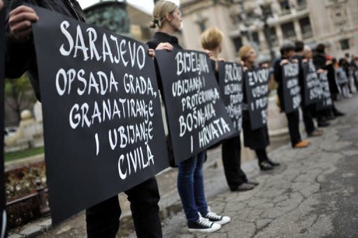 Activists of the anti-war organization "Women in Black", hold banners with the names of Bosnian cities during a protest in Belgrade this month. A Bosnian Muslim former soldier has become the first woman to be convicted of war crimes by a local court after admitting killing Croat civilians and prisoners during the 1990s war