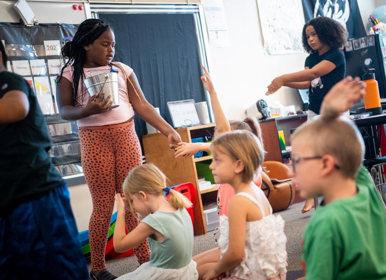 Caylee Morrion hands out erasers for a writing assignment during Monroe County Community School Corporation's Jump Start program at Summit Elementary School on Friday, July 21, 2023.