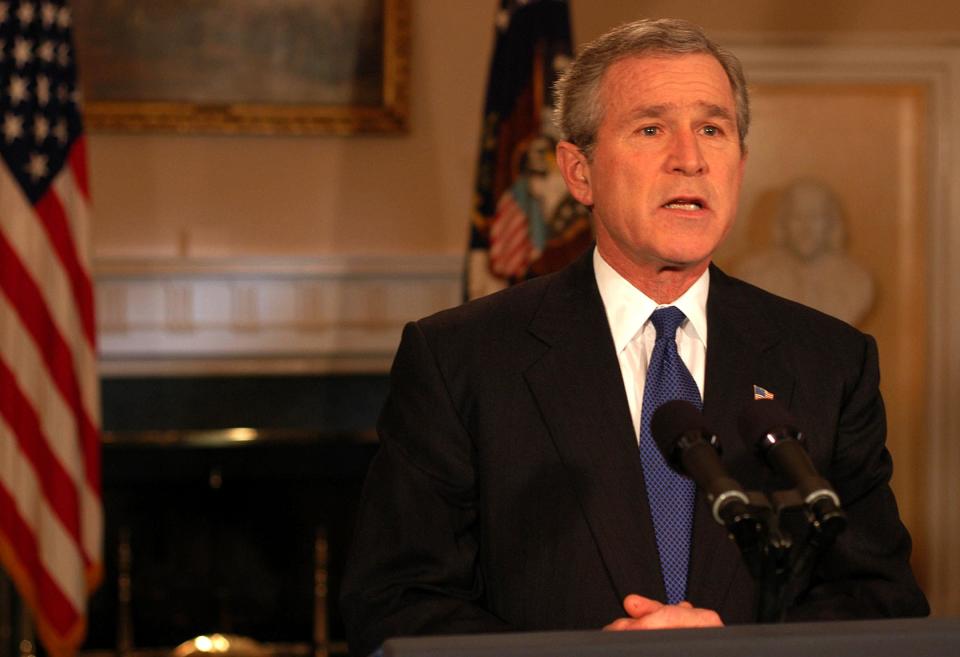 US President George W. Bush speaks about the capture of former Iraqi dictator Saddam Hussein, in the Cabinet Room of the White House in Washington, DC, 14 December 2003. According to officials, US forces captured Hussein, 13 December 2003, capping a massive eight-month manhunt by seizing him as he huddled in a camouflaged farmyard hole near his hometown of Tikrit.    AFP PHOTO/ NICHOLAS ROBERTS        (Photo credit should read NICHOLAS ROBERTS/AFP via Getty Images)