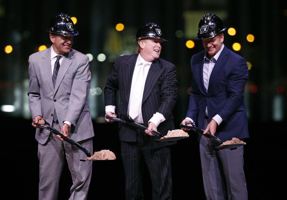 FILE--In this Nov. 13, 2017, file photo, Oakland Raiders owner Mark Davis, center, poses beside Nevada Gov. Brian Sandoval, left, and NFL Commissioner Roger Goodell during a ceremonial groundbreaking for the NFL football team's stadium in Las Vegas. Construction work on the stadium has so far exceeded the target for minority and women hiring. (AP Photo/John Locher, file)