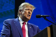 FILE - Former President Donald Trump speaks at the National Rifle Association Convention in Indianapolis, Friday, April 14, 2023. The opening phase of the Republican presidential primary has largely centered on Trump and Florida Gov. Ron DeSantis' escalating collision. But a new wave of GOP White House hopefuls will begin entering the race as soon as next week following a months'-long lull. (AP Photo/Michael Conroy, File)