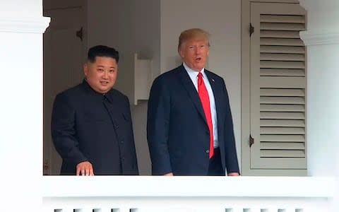 U.S. President Donald Trump, right, and North Korean leader Kim Jong Un walk together during their official meetings - Credit: AP