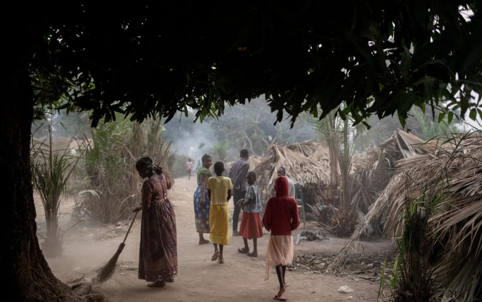 Asylum-seekers walk between shelters in Congo Rive village, Democratic Republic of Congo, after fleeing Bangui when rebels attacked - Adrienne Surprenant/UNHCR