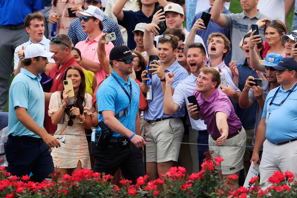 Scottie Scheffler walks past the gallery watching action on the 17th hole of the Players Stadium Course at TPC Sawgrass during the final round of his 2023 victory at The Players.