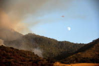 An air tanker prepares to drop retardant on the Windy Fire burning on Tule River Reservation in California on Thursday, Sept. 16, 2021. The fire has burned into the Peyrone Sequoia Grove and continues to threaten other sequoias according to fire officials. (AP Photo/Noah Berger)