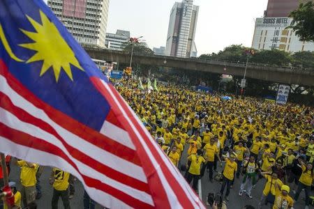 Protesters exercise during a rally organised by pro-democracy group "Bersih" (Clean) near Dataran Merdeka in Malaysia's capital city of Kuala Lumpur, August 30, 2015. REUTERS/Athit Perawongmetha