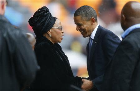 U.S. President Obama pays his respect to Graca Machel at the memorial service for Nelson Mandela in Johannesburg