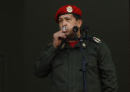 El presidente venezolano Hugo Chávez besa un crucifijo tras dirigirse a sus seguidores desde un balcón del palacio de Miraflores, el 4 de julio de 2011, a su llegada de Cuba. AP Photo/Ariana Cubillos