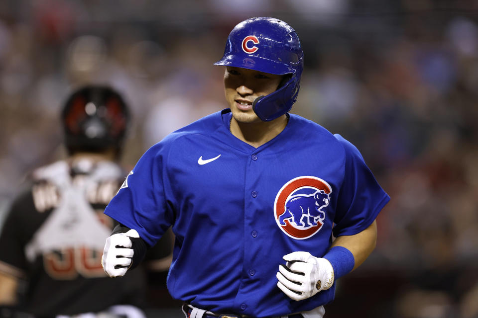 Chicago Cubs' Seiya Suzuki scores a run on a walk during the ninth inning of the team's baseball game against the Arizona Diamondbacks on Saturday, May 14, 2022, in Phoenix. (AP Photo/Chris Coduto)