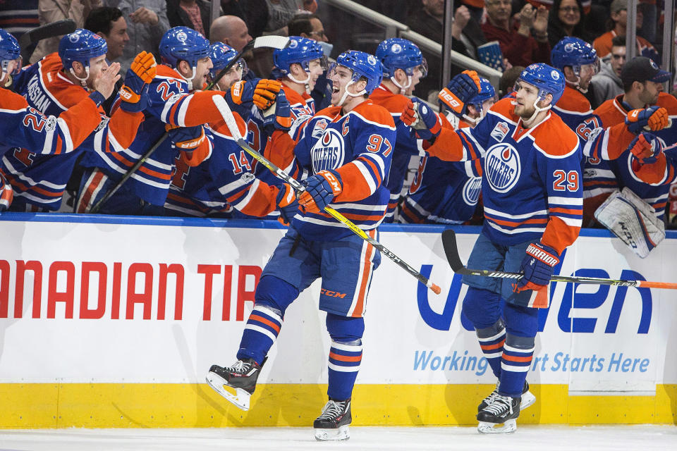 Edmonton Oilers' Connor McDavid (97) and Leon Draisaitl (29) celebrate a goal against the Vancouver Canucks during the third period of an NHL hockey game in Edmonton, Alberta, Sunday, April 9, 2017. (Amber Bracken/The Canadian Press via AP)