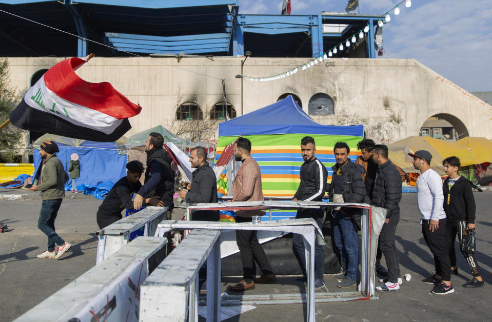 Protesters go through security inspection as they arrive to Tahrir Square, during ongoing protests, in Baghdad, Iraq, Wednesday, Dec. 25, 2019. (AP Photo/Nasser Nasser)