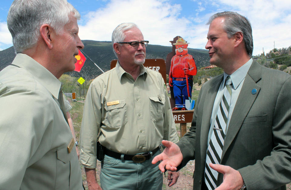 Bernalillo County Commissioner Wayne Johnson, right, talks to U.S. Forest Service Chief Tom Tidwell, left, and Regional Forester Corbin Newman, center, about wildfire response after a news conference at the Sandia Ranger Station in Tijeras, N.M on Thursday, April 26, 2012. Federal officials expect the 2012 season to be just as active as last year, when historic fires charred hundreds of square miles across parts of Arizona, New Mexico and Texas. (AP Photo/Susan Montoya Bryan)