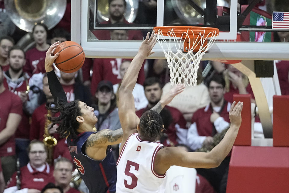 Jackson State forward Trace Young (3) goes up for a dunk against Indiana forward Malik Reneau (5) during the second half of an NCAA college basketball game, Friday, Nov. 25, 2022, in Bloomington, Ind. (AP Photo/Darron Cummings)