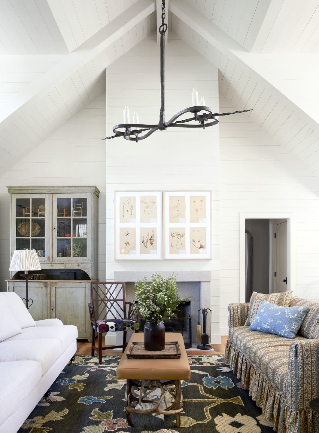 white lake house living room with large fireplace