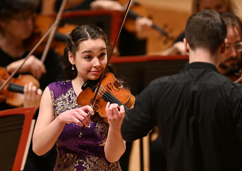 Alina Baron looks up at assistant conductor Matthew Straw as she plays the violin during the Salute to Youth concert at Abravanel Hall in Salt Lake City on Wednesday, Nov. 22, 2023. | Scott G Winterton, Deseret News