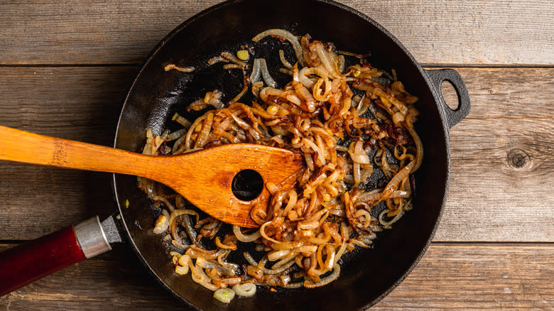 Caramelzed onions with wooden spatula 