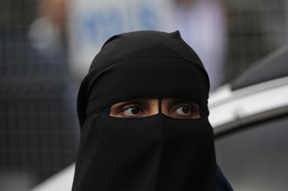 A woman waits near the Saudi Arabia consulate in Istanbul, during a protest in support of the missing Saudi writer Jamal Khashoggi, Monday, Oct. 8, 2018. Khashoggi, 59, went missing on Oct 2 while on a visit to the consulate in Istanbul for paperwork to marry his Turkish fiancée. The consulate insists the writer left its premises, contradicting Turkish officials. He had been living since last year in the U.S. in a self-imposed exile, in part due to the rise of Prince Mohammed, the son of King Salman. (AP Photo/Lefteris Pitarakis)